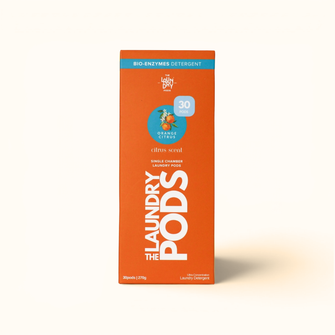 The Laundry Pods orange citrus box beside fresh oranges